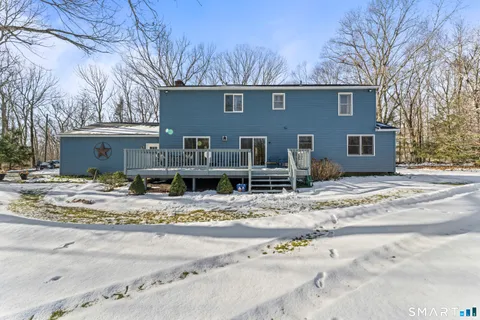 a view of a house with snow on the road