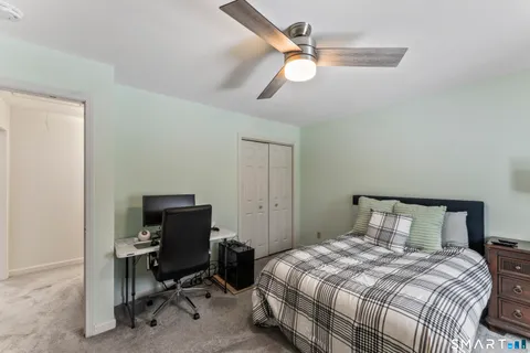 a bedroom with a bed and a chair