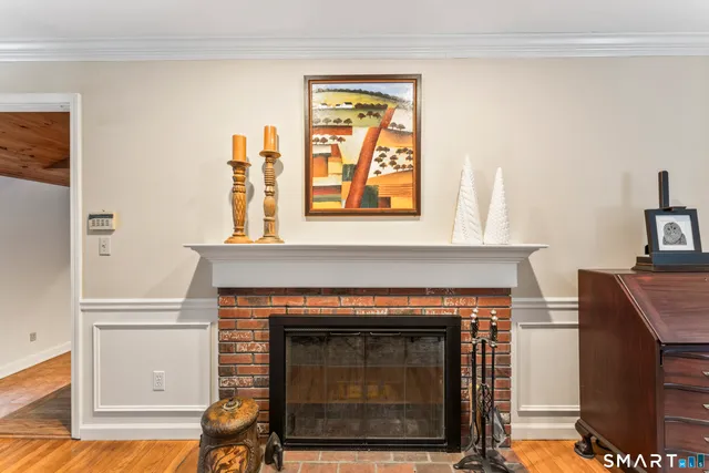 a living room with a fireplace and a table
