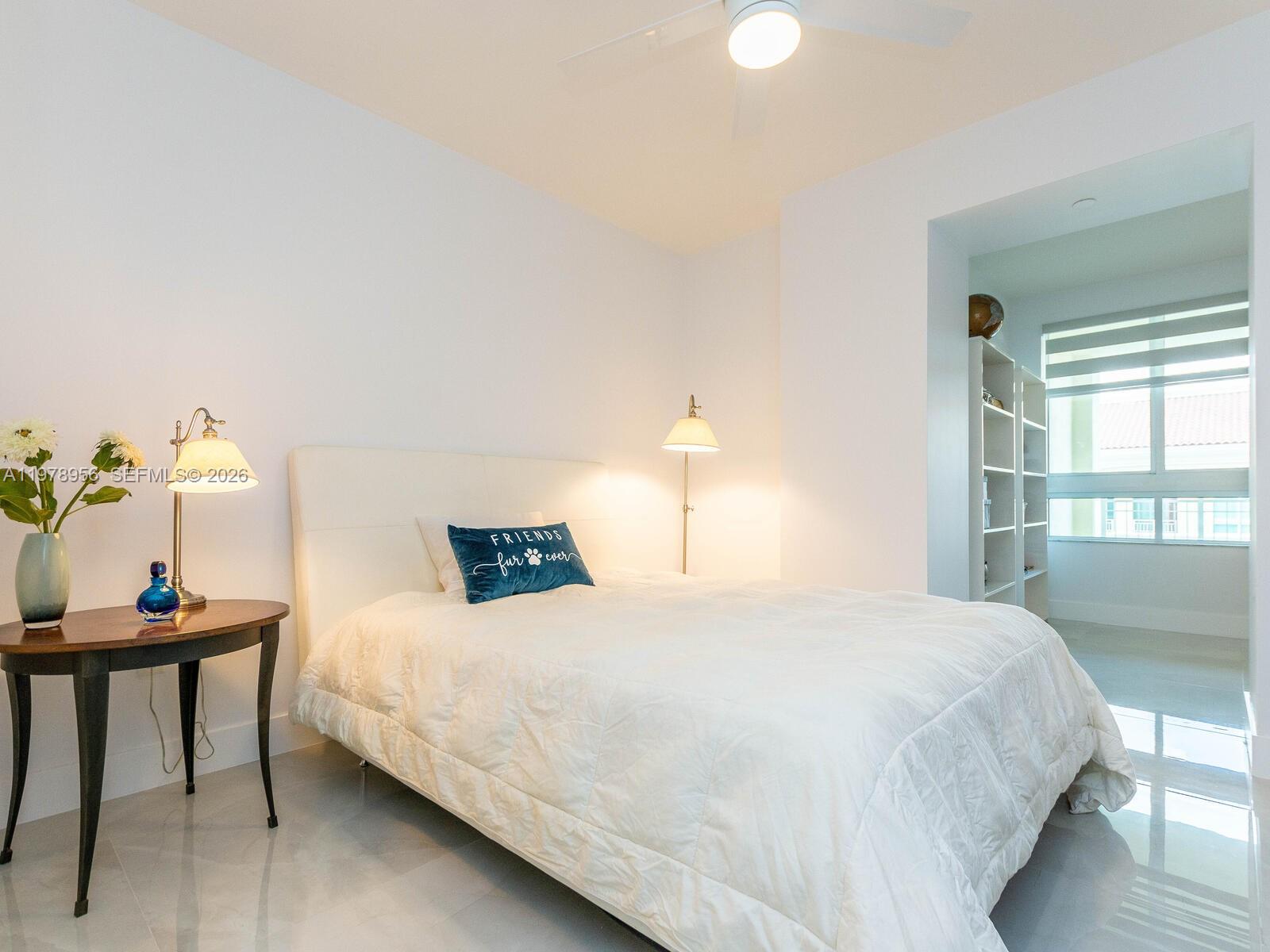 7350 Southwest 89th Street, Unit 719S Miami, FL 33156 - Photo 21 of 30 a bedroom with a bed table and a window