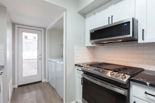 a kitchen with a stove and a microwave