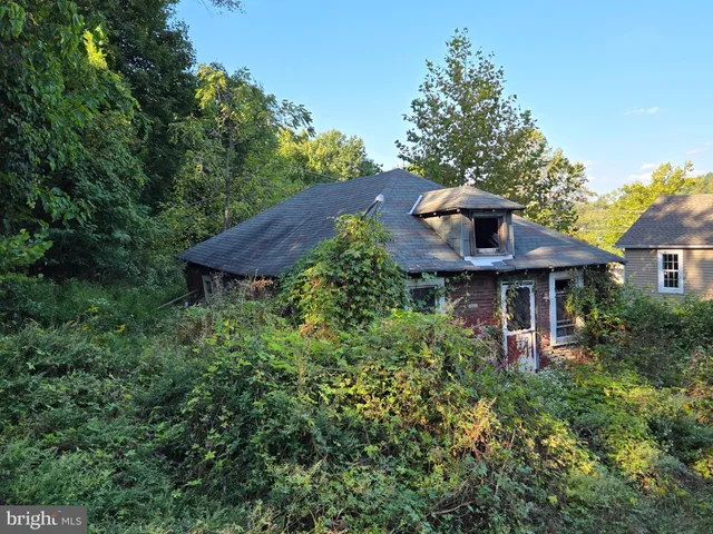 a view of a house with a yard and a garden
