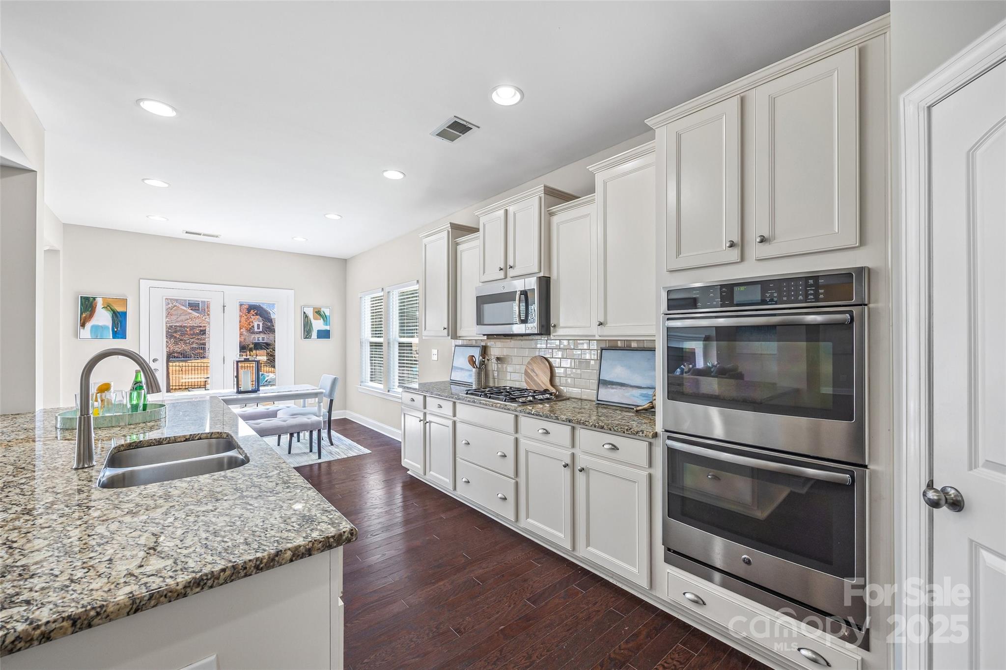 84324 Masterson Court Lancaster, SC 29720 - Photo 13 of 45 a kitchen with stainless steel appliances granite countertop a stove top oven and sink