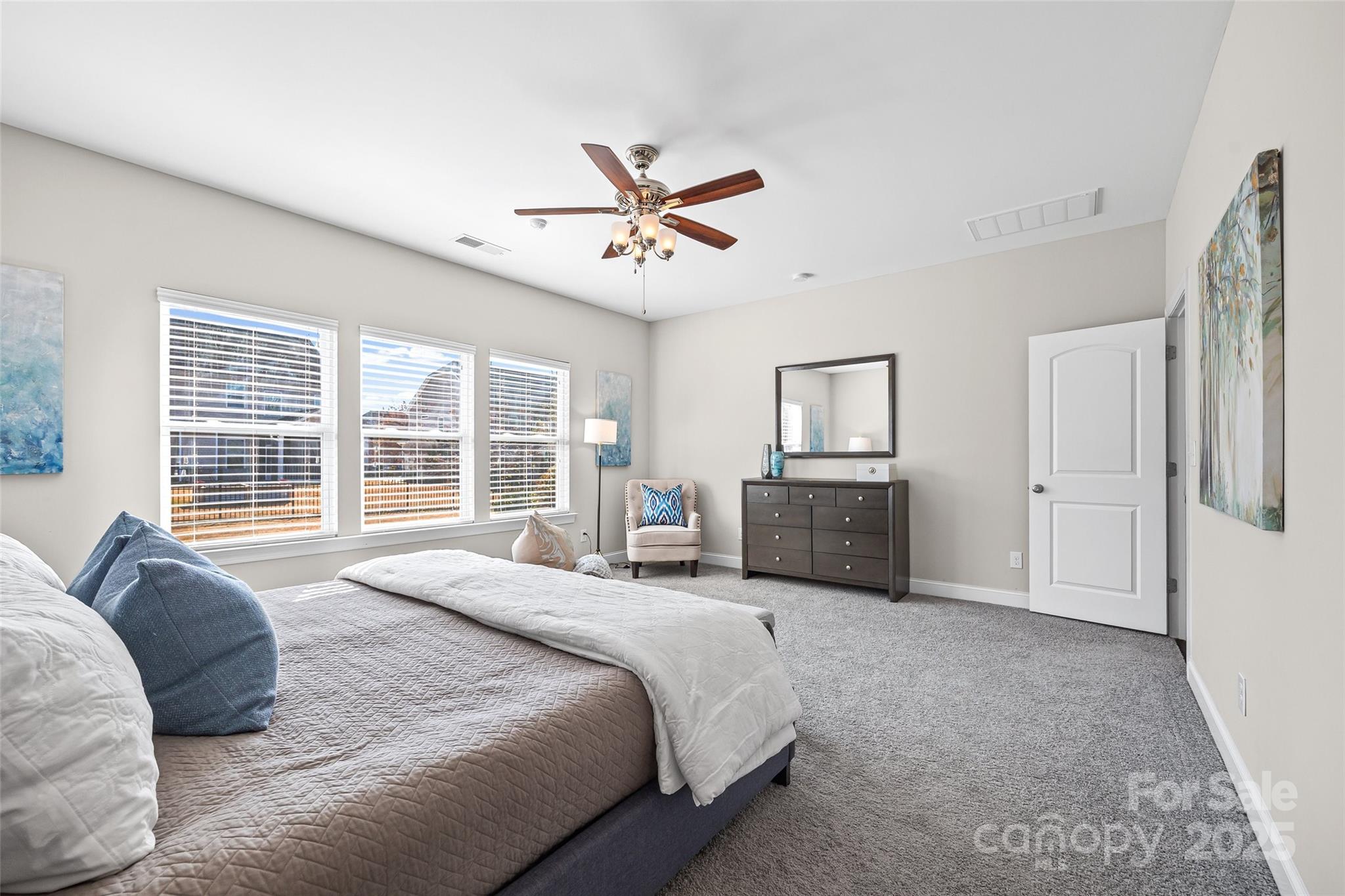 84324 Masterson Court Lancaster, SC 29720 - Photo 17 of 45 a spacious bedroom with a bed a dresser and a large window