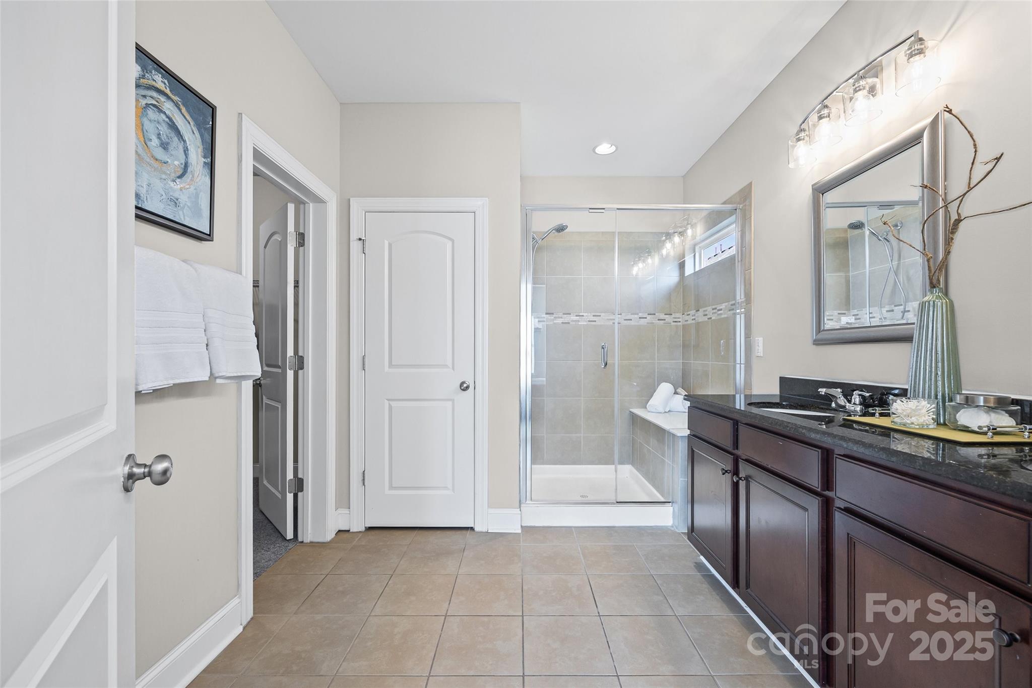 84324 Masterson Court Lancaster, SC 29720 - Photo 18 of 45 a bathroom with a double vanity sink a mirror and a shower