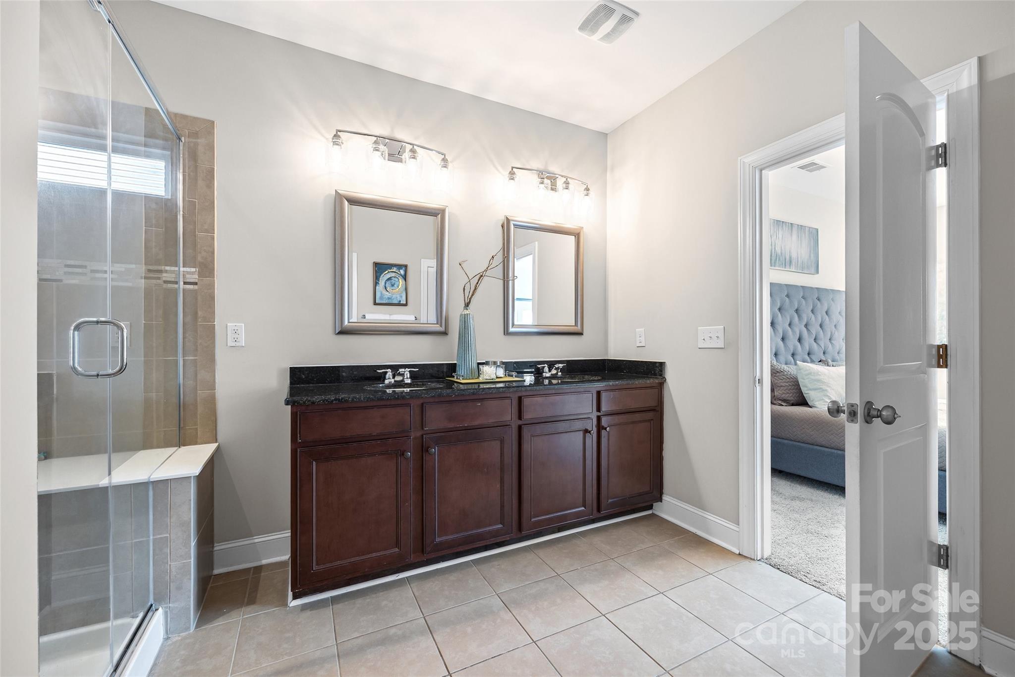 84324 Masterson Court Lancaster, SC 29720 - Photo 19 of 45 a spacious bathroom with a granite countertop sink mirror and shower
