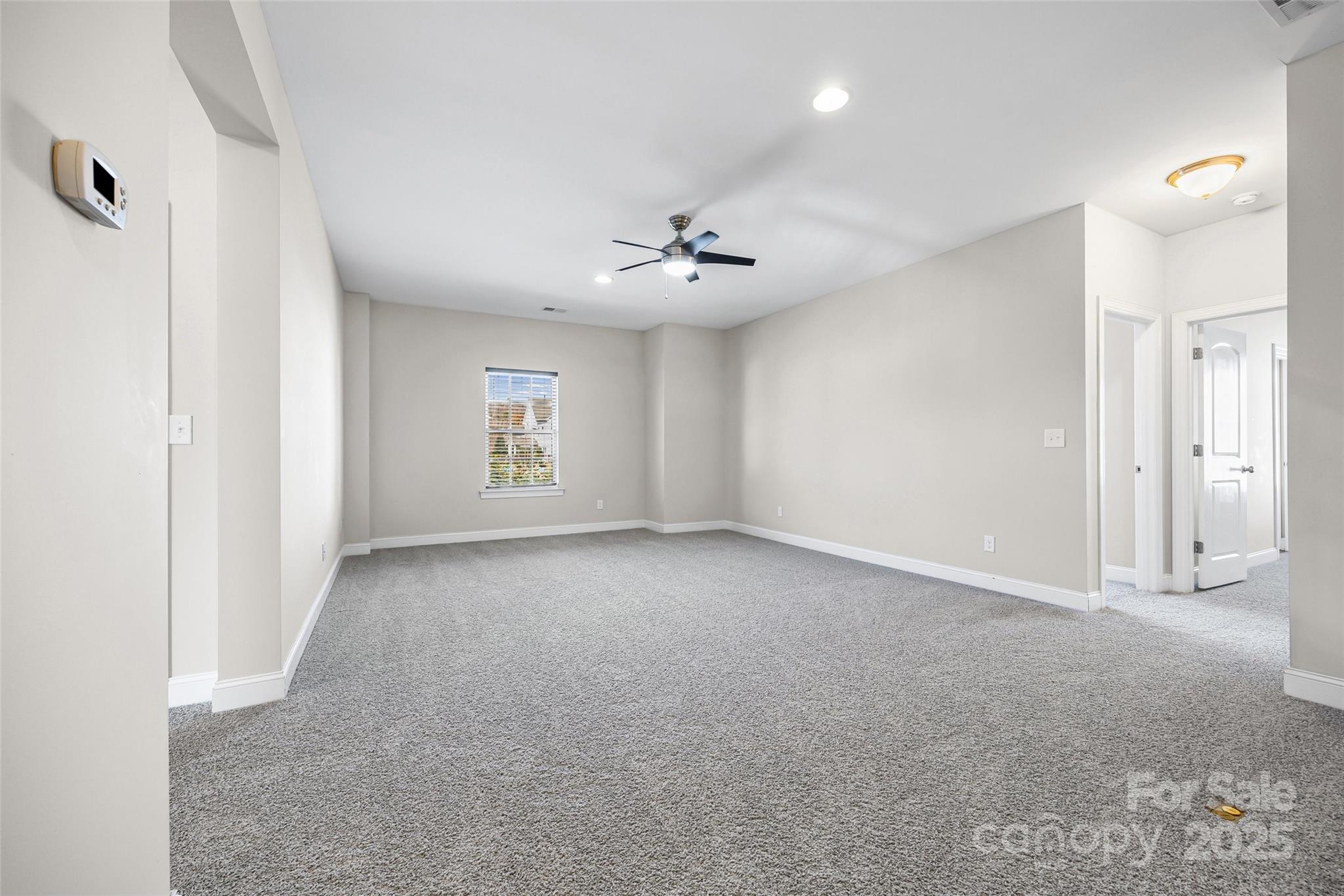 84324 Masterson Court Lancaster, SC 29720 - Photo 21 of 45 an empty room with a ceiling fan and a window