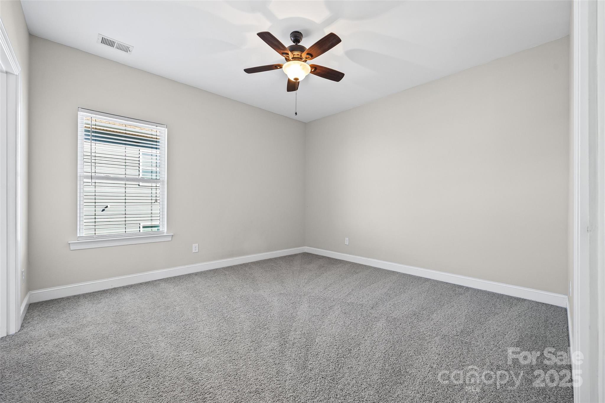84324 Masterson Court Lancaster, SC 29720 - Photo 30 of 45 an empty room with ceiling fan and window
