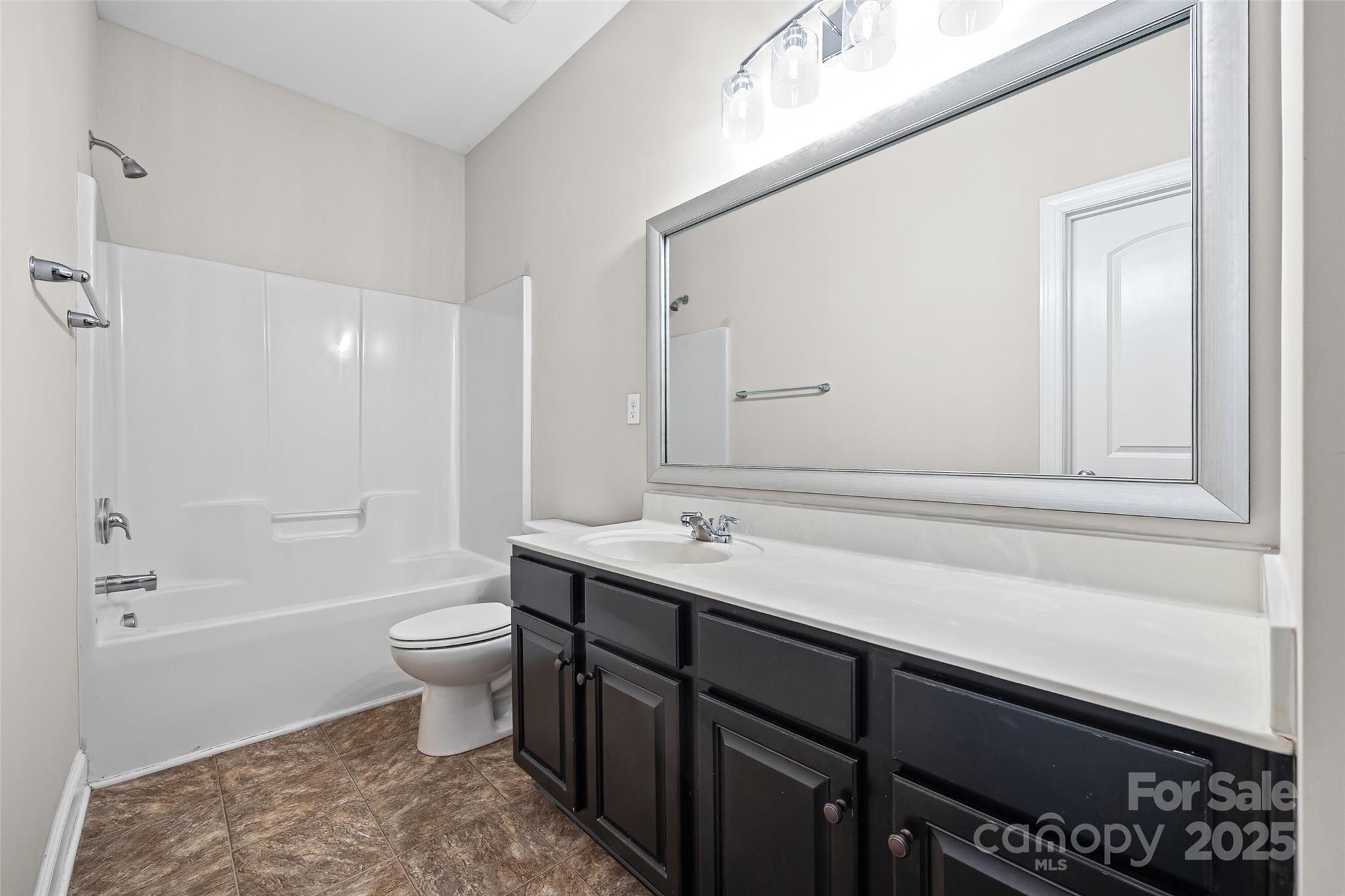 84324 Masterson Court Lancaster, SC 29720 - Photo 32 of 45 a bathroom with a sink a toilet a mirror and bathtub