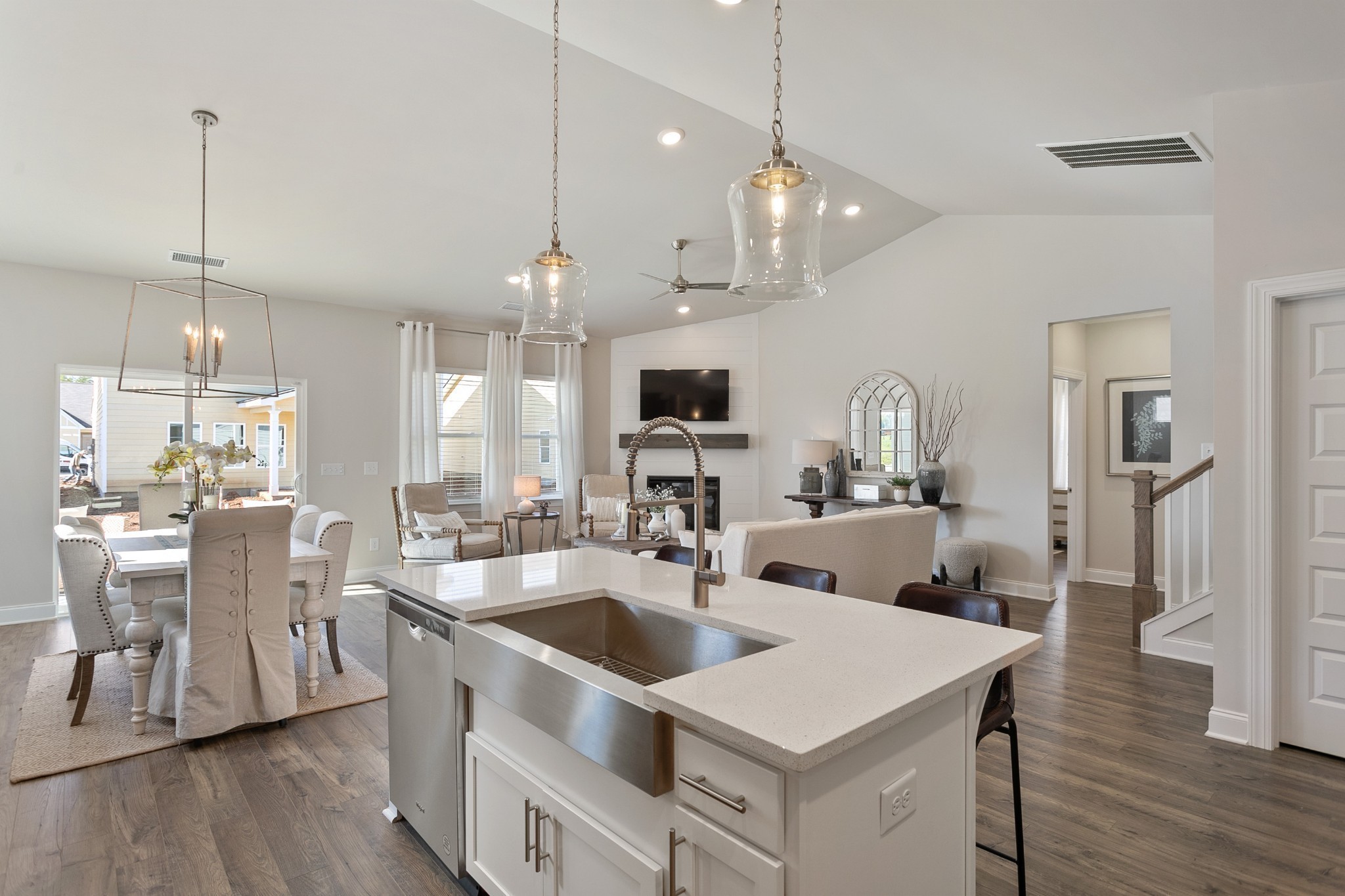 9132 Ristau Drive Antioch, TN 37013 - Photo 4 of 19 a kitchen with center island a sink dishwasher a dining table and chairs with wooden floor