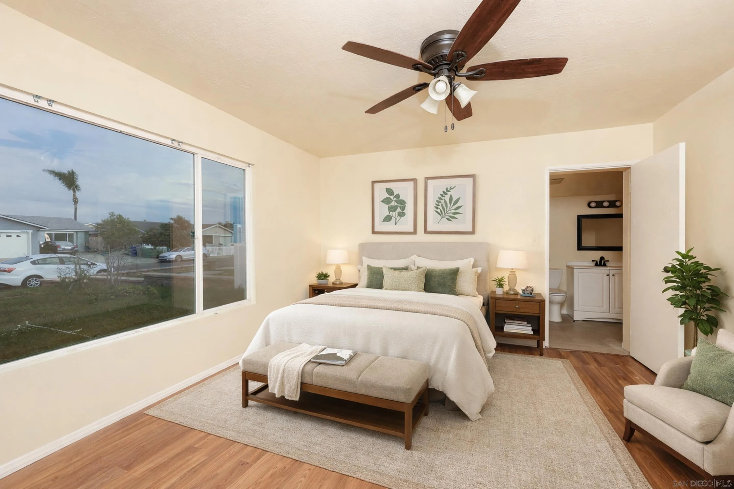 10866 Sandy Hook Road San Diego, CA 92126 - Photo 2 of 15 a bedroom with a large bed and a chandelier