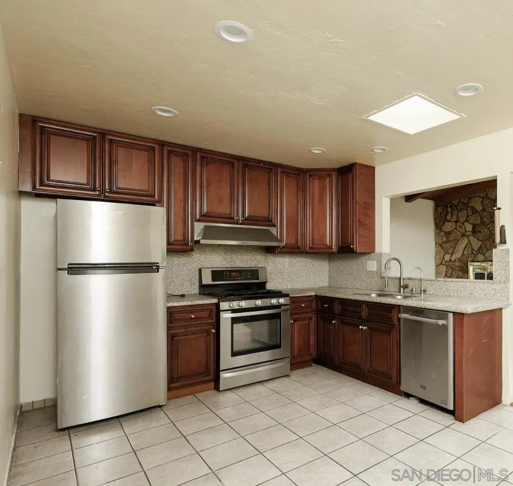 10866 Sandy Hook Road San Diego, CA 92126 - Photo 6 of 15 a kitchen with stainless steel appliances granite countertop a refrigerator sink and cabinets