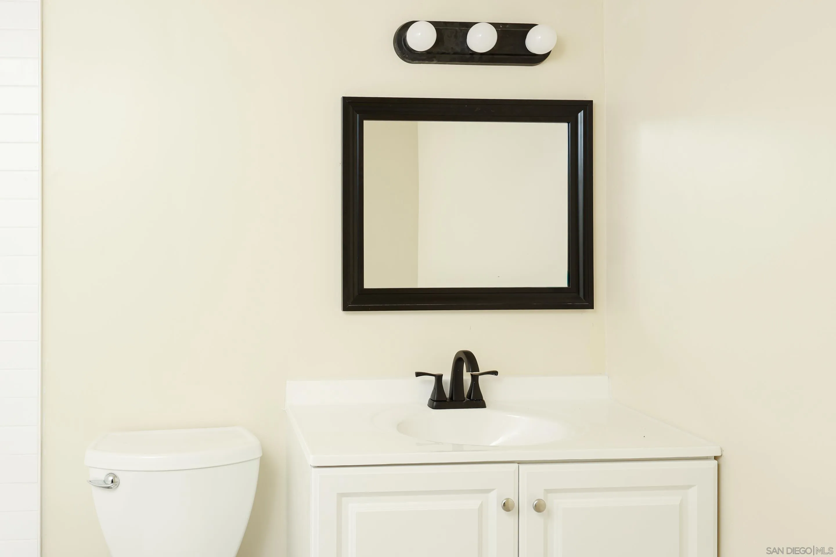 10866 Sandy Hook Road San Diego, CA 92126 - Photo 7 of 15 a bathroom with a toilet sink and mirror