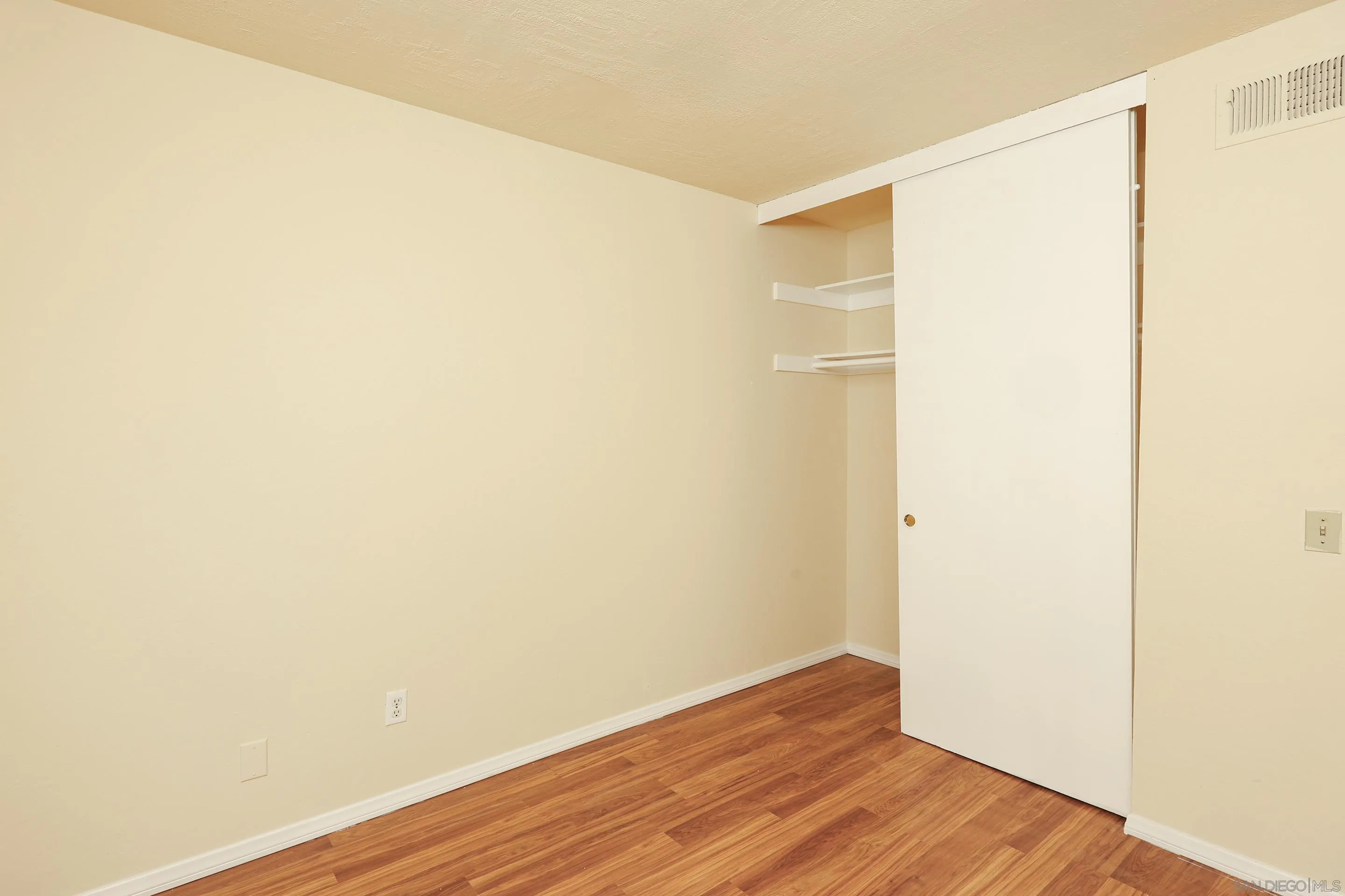 10866 Sandy Hook Road San Diego, CA 92126 - Photo 10 of 15 a view of an empty room with wooden floor