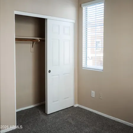an empty room with windows and closet