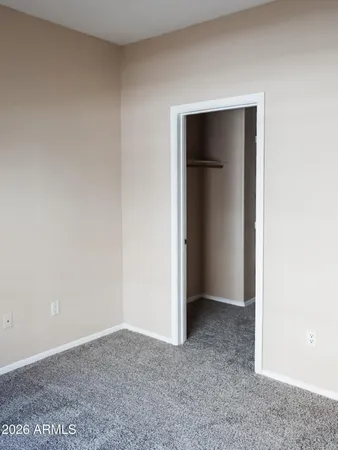 a view of an empty room with closet and closet
