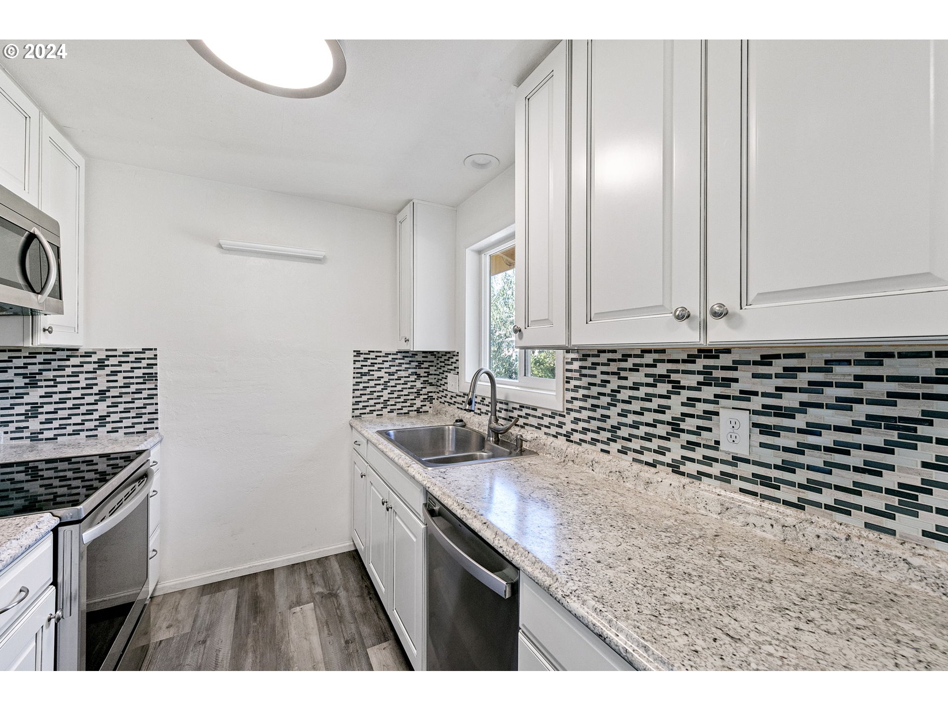 5736 Thurston Road Springfield, OR 97478 - Photo 16 of 38 a kitchen with a sink and cabinets