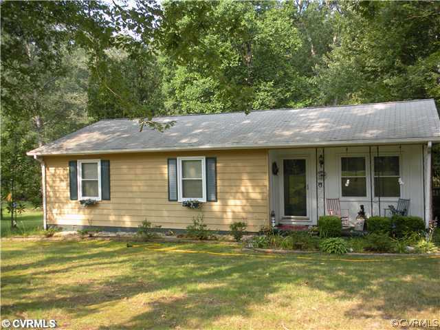 6900 Egypt Road New Kent, VA 23124 - Photo 1 of 1 a front view of a house with a garden and outdoor seating