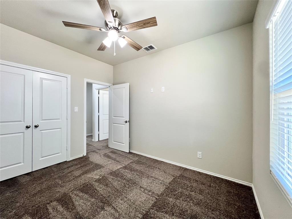 3501 East Renfro Street, Unit 202 Burleson, TX 76028 - Photo 32 of 33 a view of a livingroom with a ceiling fan and window