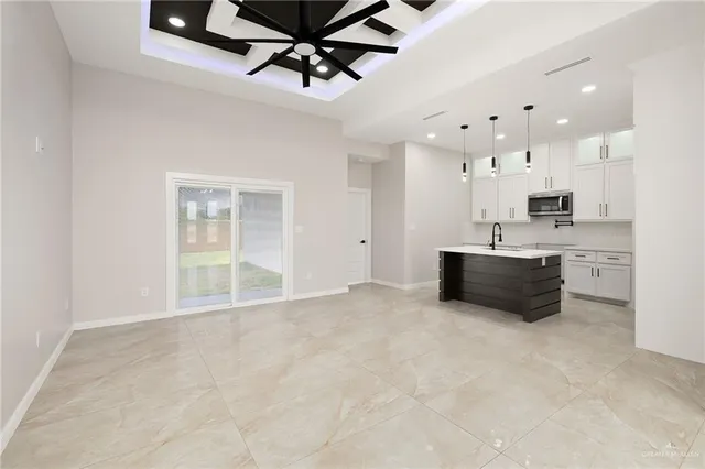 a kitchen with stainless steel appliances a sink and a refrigerator