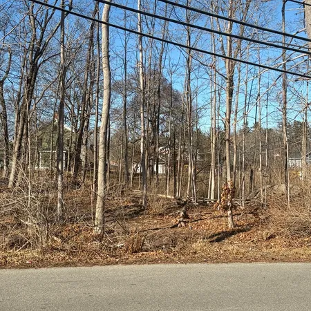 a view of yard with wooden fence