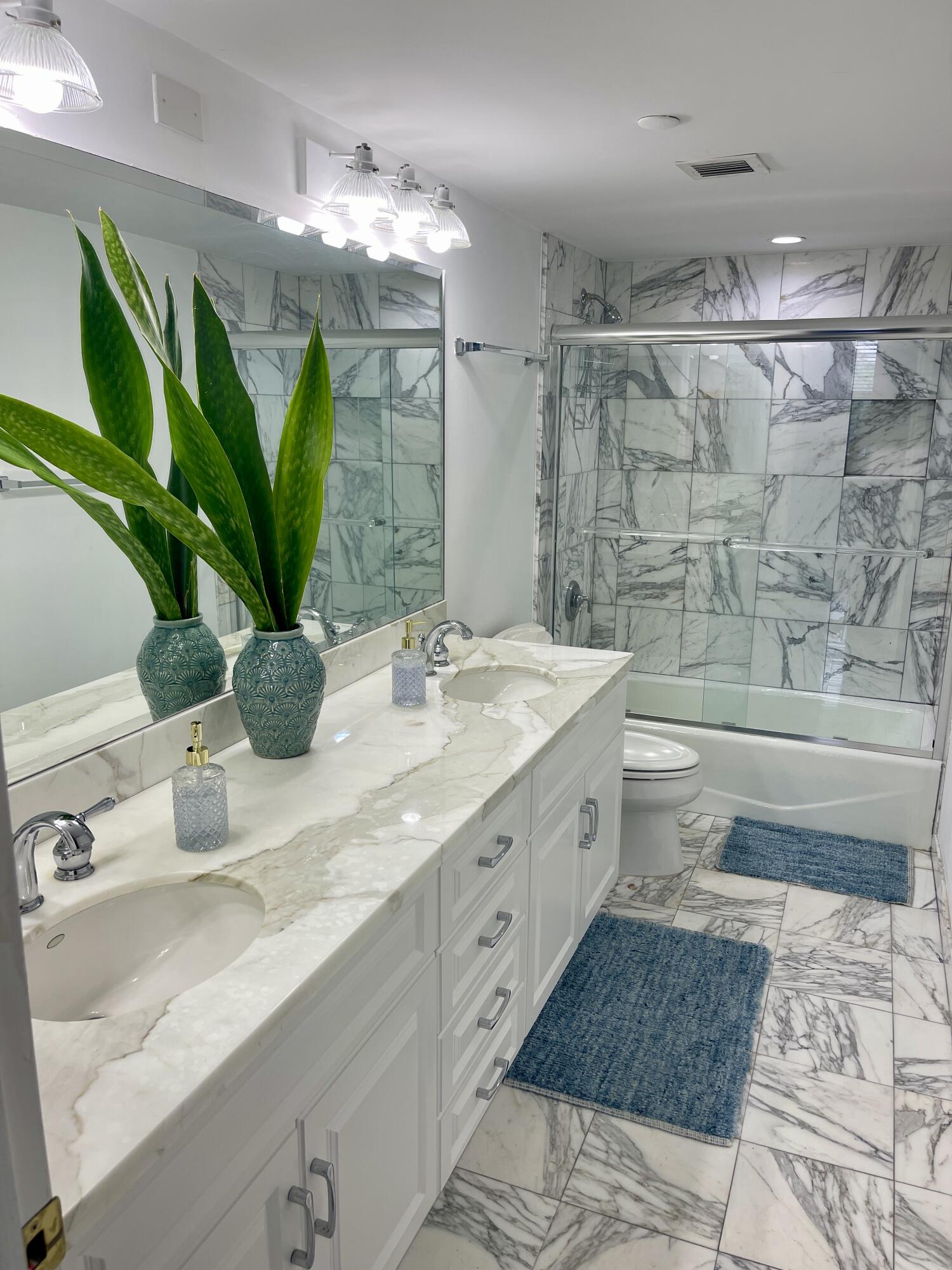 2001 North Ocean Boulevard, Unit 301 Boca Raton, FL 33431 - Photo 17 of 41 a bathroom with a double vanity sink and a mirror