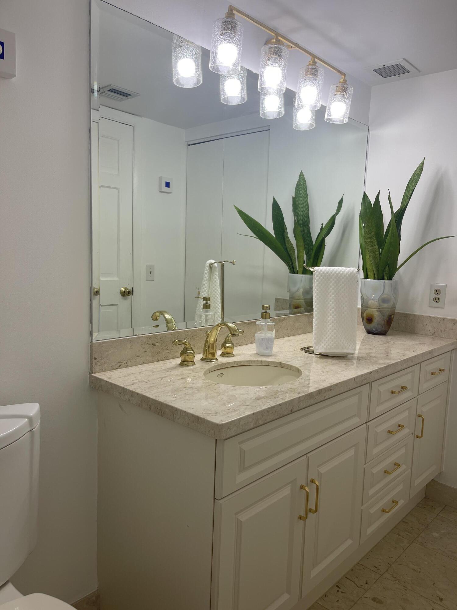 2001 North Ocean Boulevard, Unit 301 Boca Raton, FL 33431 - Photo 18 of 41 a bathroom with a sink a vanity and a mirror