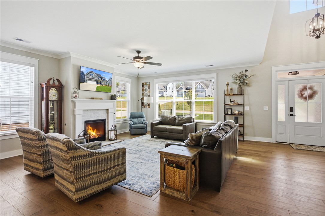 318 Summerall Drive Anderson, SC 29621 - Photo 4 of 42 This inviting living space features gleaming hardwood floors and a cozy fireplace, perfect for gatherings.