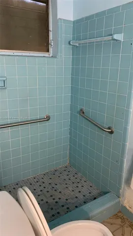 a backyard of a house with barbeque oven fire pit table and chairs