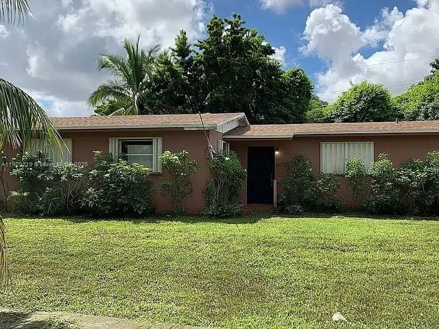 a view of a swimming pool with a table and chairs in patio