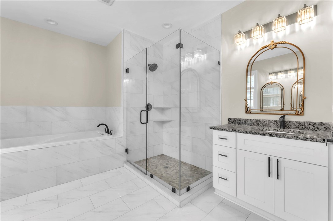 1015 Winmar Drive Anderson, SC 29621 - Photo 25 of 49 This primary bathroom features a spacious soaking tub, a sleek walk-in shower, and a stylish vanity with ample storage.