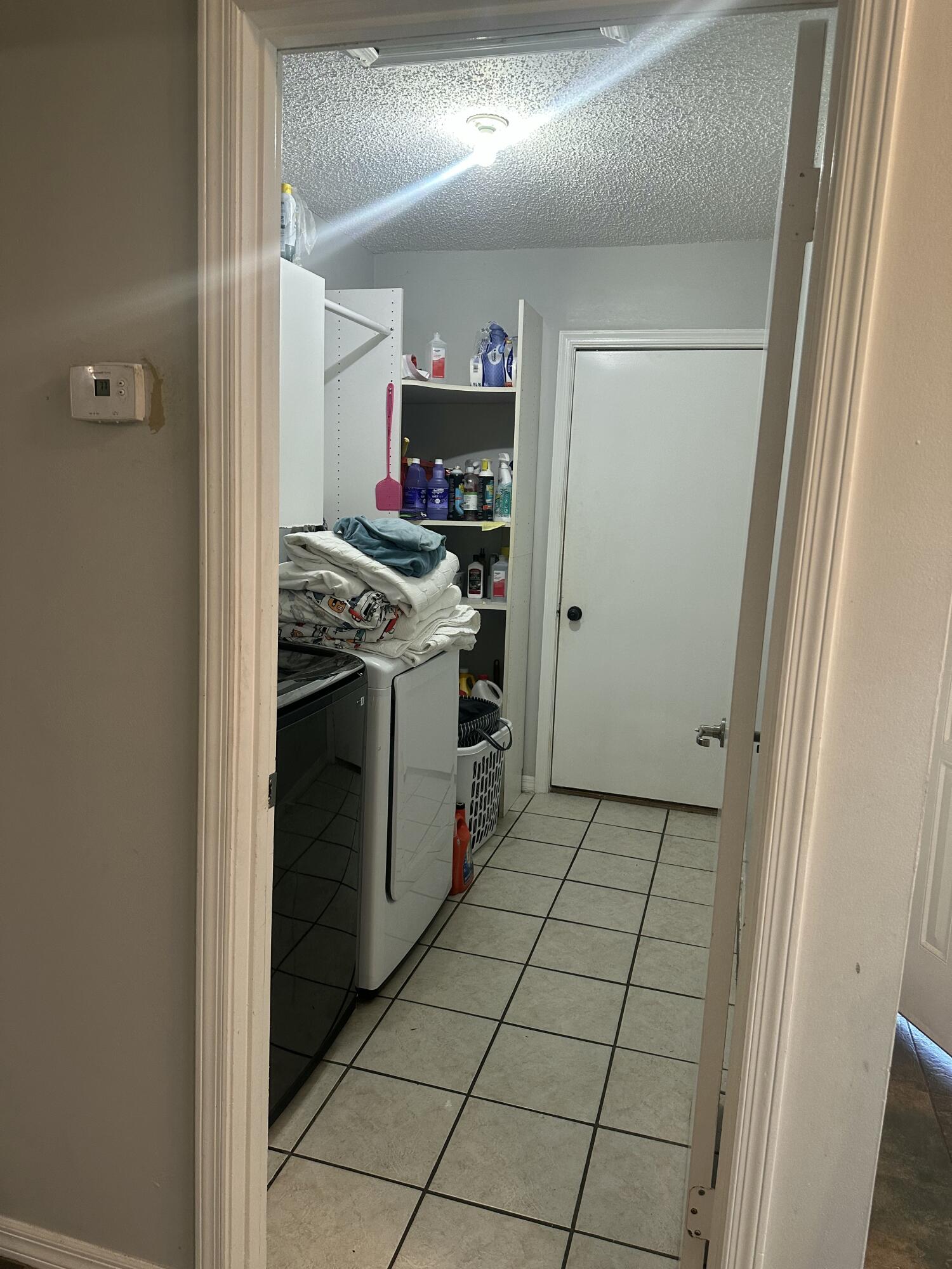 8812 Southeast Sandridge Avenue Hobe Sound, FL 33455 - Photo 12 of 22 a kitchen with a stove and a refrigerator