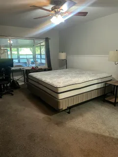 a view of walk in closet with clothes