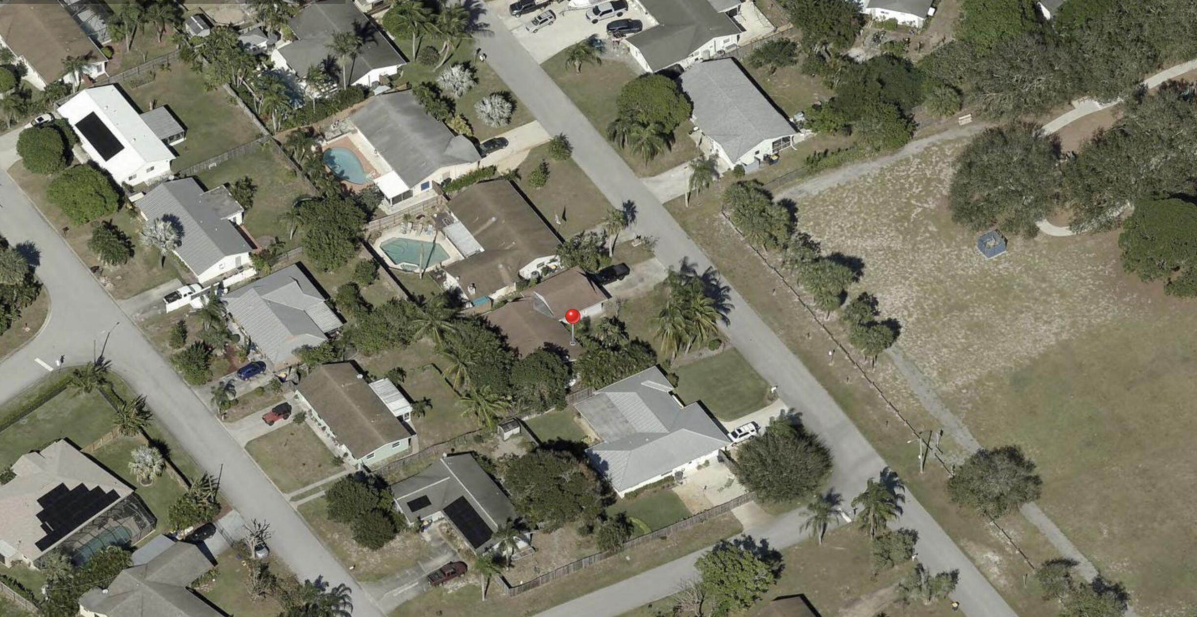 8812 Southeast Sandridge Avenue Hobe Sound, FL 33455 - Photo 19 of 22 an aerial view of residential houses with outdoor space