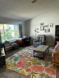 a view of a livingroom with furniture and windows