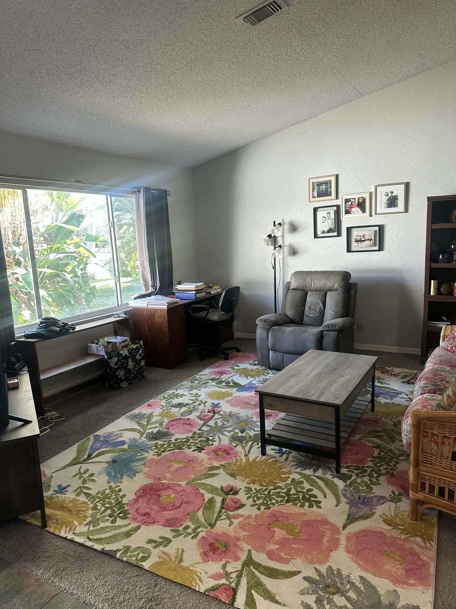 8812 Southeast Sandridge Avenue Hobe Sound, FL 33455 - Photo 6 of 22 a living room with furniture and a table