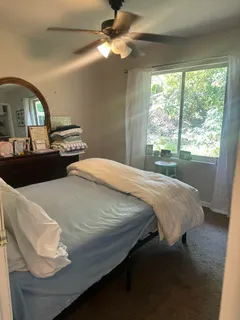 a bathroom with a sink a toilet and shower curtain