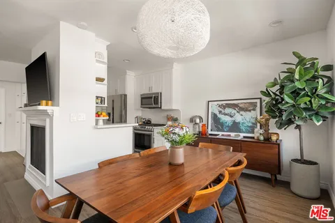 a dining room with furniture and wooden floor