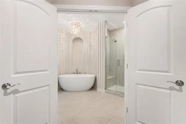 a spacious bathroom with a bathtub sink and mirror