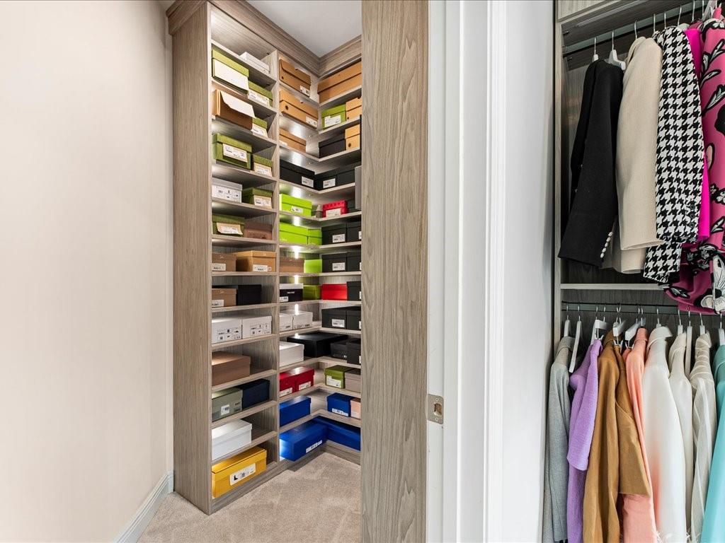 120 Via Roma Woodstock, GA 30188 - Photo 33 of 46 a view of walk in closet with clothes and shoes
