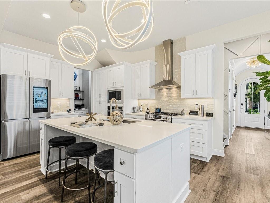 120 Via Roma Woodstock, GA 30188 - Photo 5 of 46 a kitchen with a sink a stove and chairs