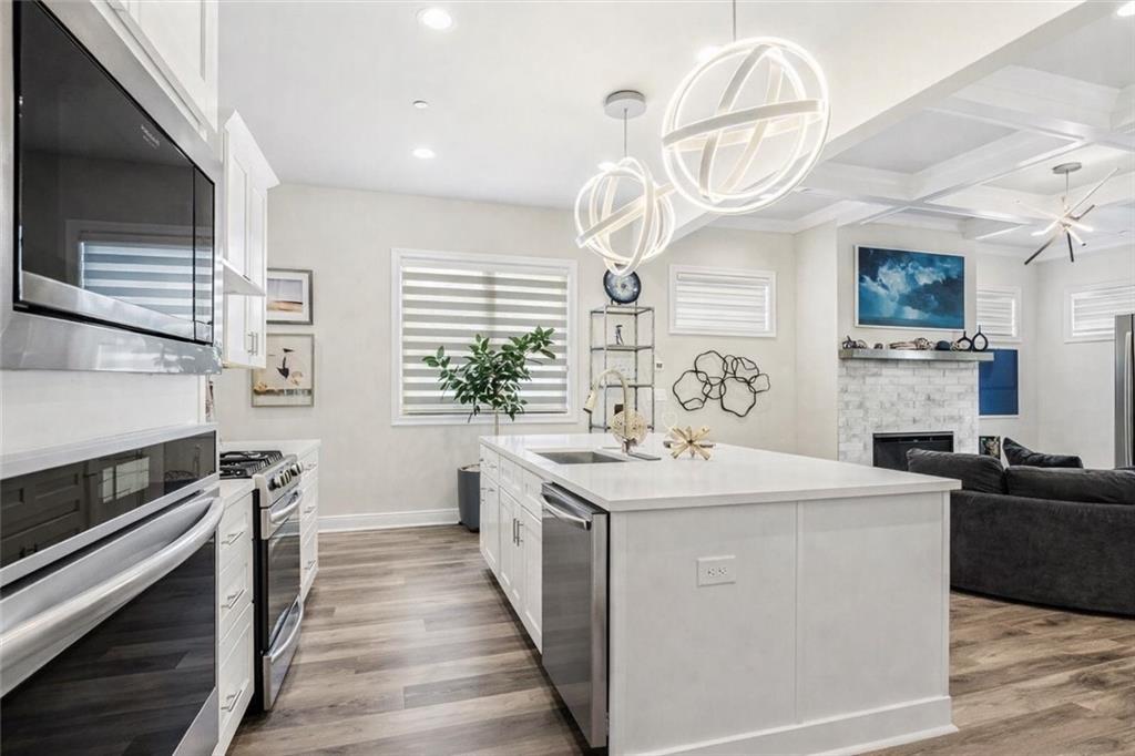 120 Via Roma Woodstock, GA 30188 - Photo 9 of 46 a kitchen with a sink a stove oven a counter space and cabinets