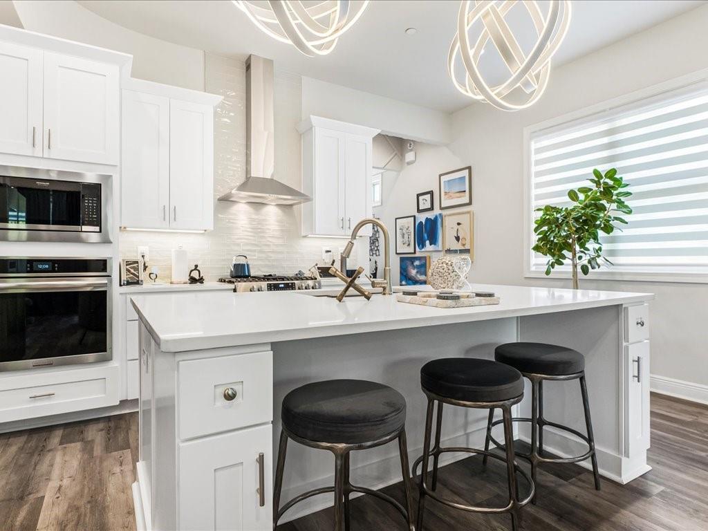 120 Via Roma Woodstock, GA 30188 - Photo 10 of 46 a kitchen with stainless steel appliances a stove a sink and a refrigerator