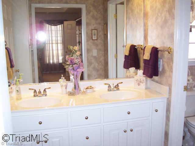 511 West Lebanon Road Mebane, NC 27302 - Photo 6 of 8 Other. Master suite s Dressing Area W/ a Walk-in Closet, Cabinets to the Ceiling & a Double Vanity.