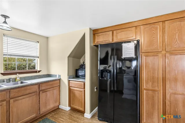 a kitchen with a refrigerator and a sink