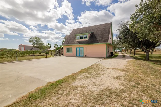 a view of a house with a snow on the road