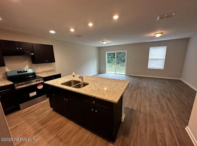 a kitchen with a sink and a stove top oven