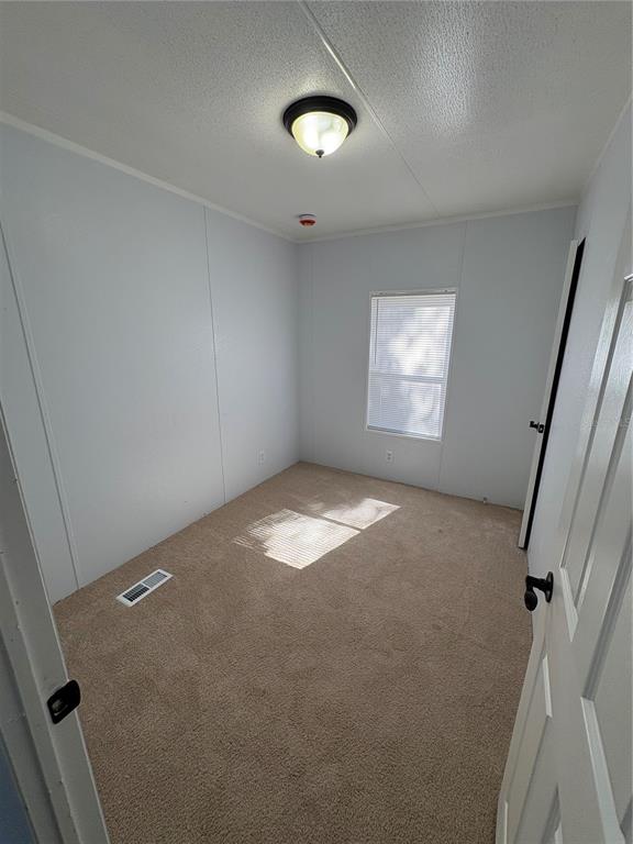 8939 Beverly Hills Road Lakeland, FL 33809 - Photo 12 of 23 an empty room with a window