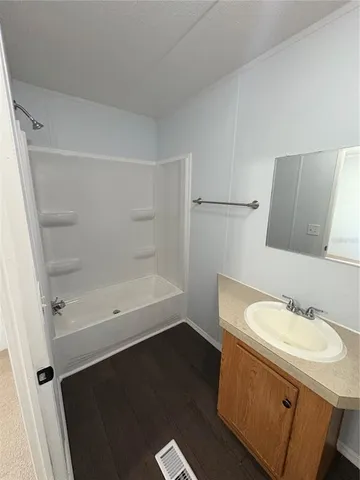 a bathroom with a sink toilet and a mirror