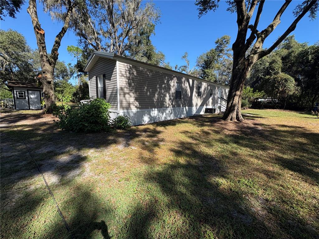 8939 Beverly Hills Road Lakeland, FL 33809 - Photo 2 of 23 a view of a yard with plants and trees